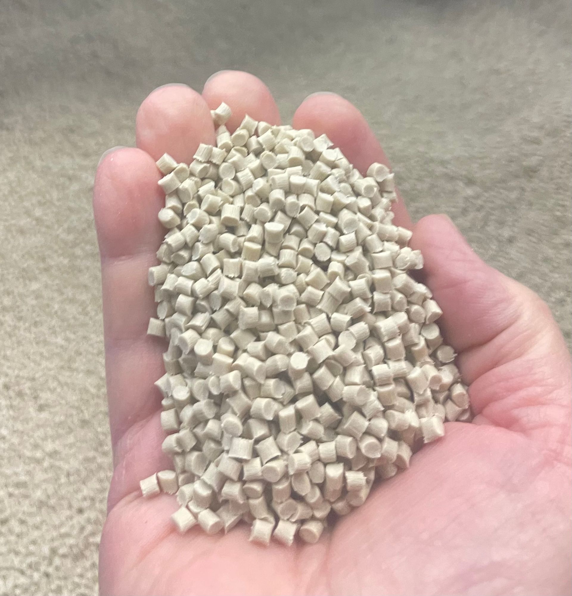 Image of male hand holding a handful of resin