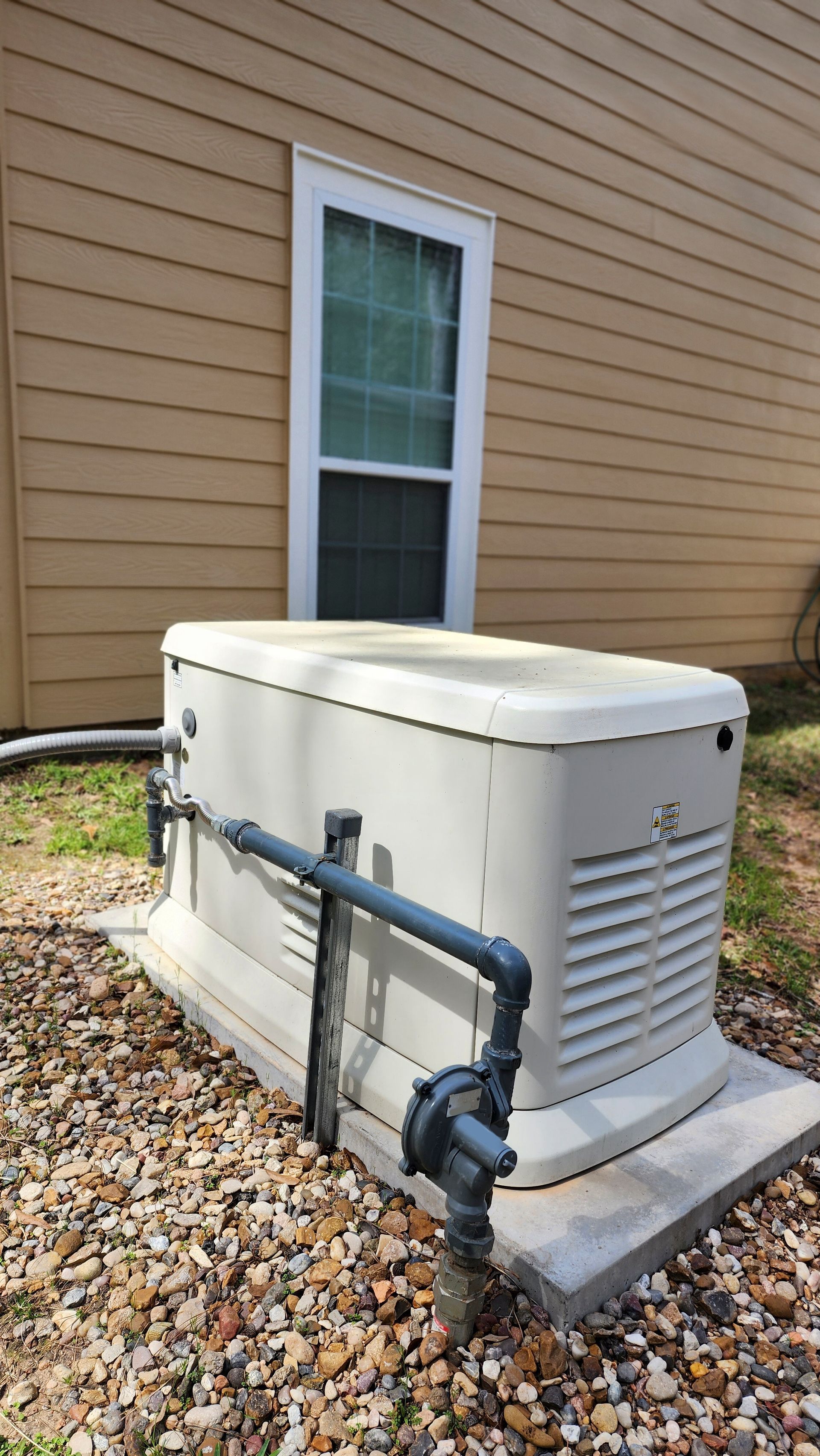 A standby generator providing backup power to a home after a successful generator installation.