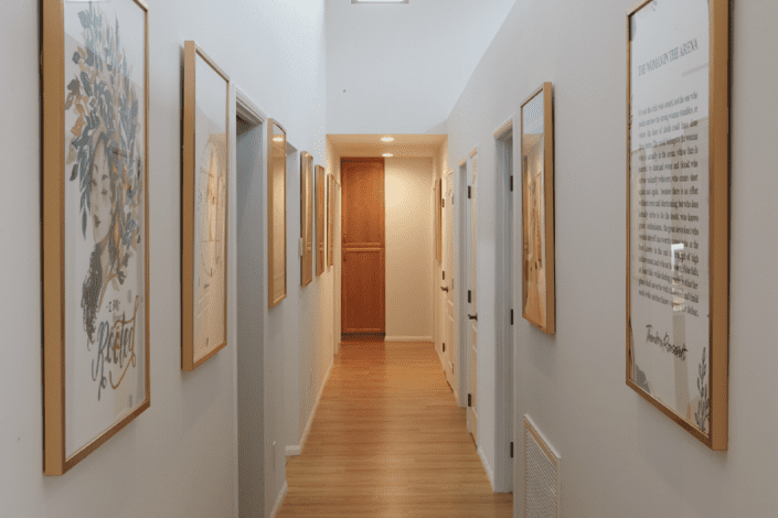 A long hallway with a lot of pictures on the wall.