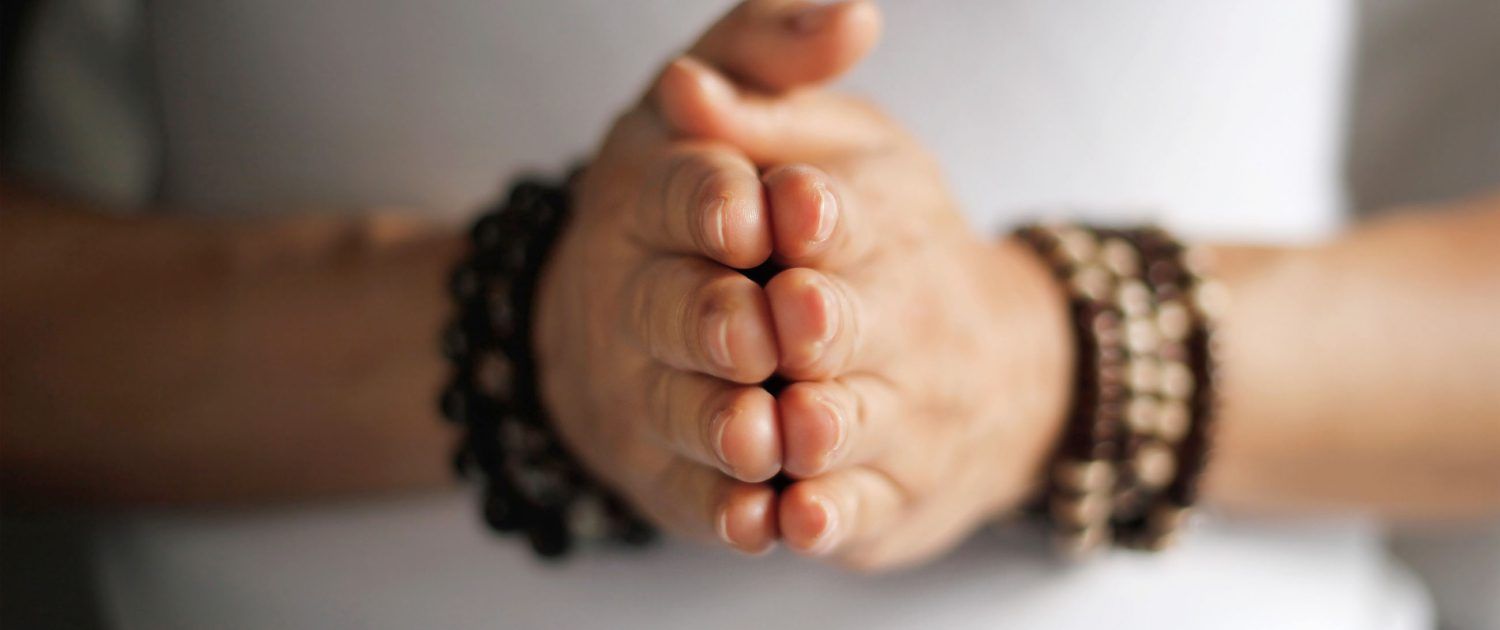 A close up of a person 's hands with bracelets on them.