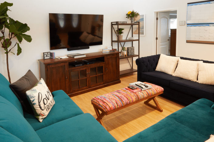 A living room with two couches and a flat screen tv