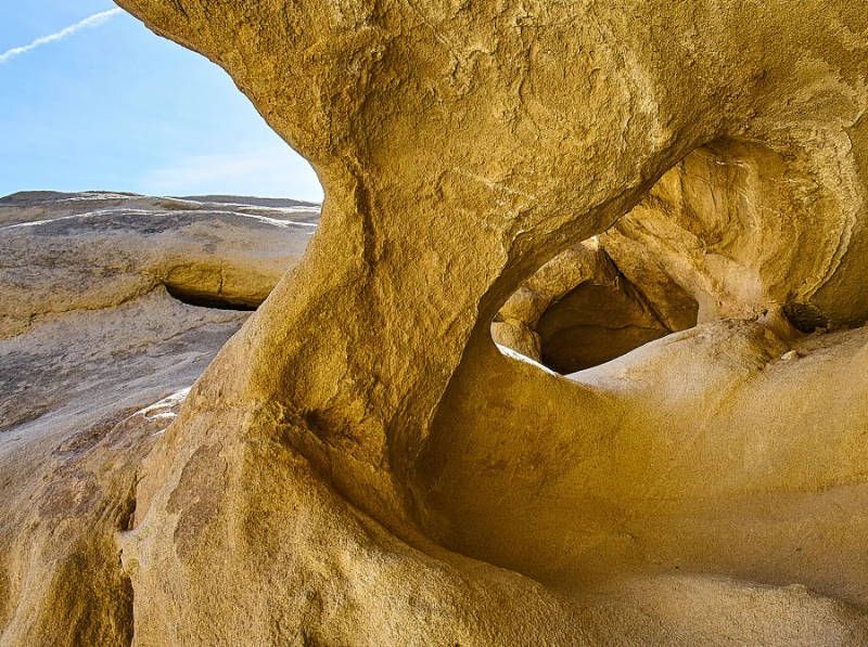 A close up of a rock formation with a blue sky in the background.