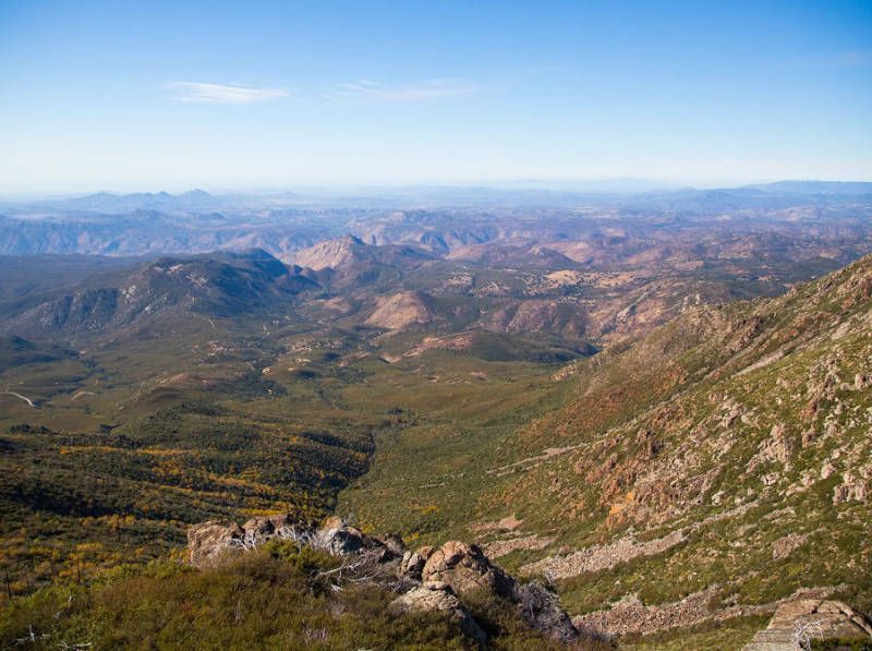 A view of a mountain valley from the top of a mountain.