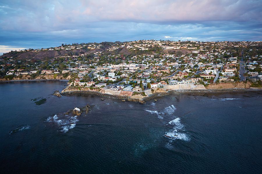 An aerial view of a city next to a body of water.