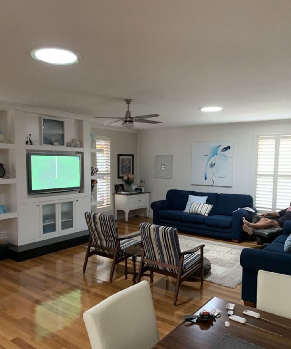Living Room With Hardwood Floors, White Walls, and Two Circular Skylights — Gold Coast Skylights in Slacks Creek, QLD