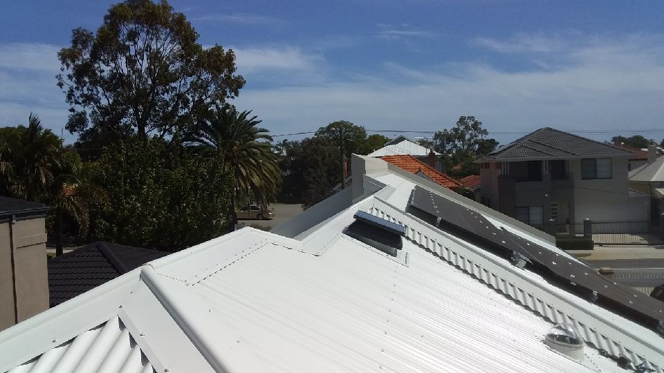 White Metal Roof With Solar Panels and Bird Deterrents on a Residential Building — Gold Coast Skylights in Slacks Creek, QLD