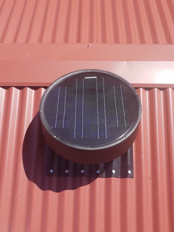 A Round, Solar-powered Vent on a Reddish Corrugated Metal Roof — Gold Coast Skylights in Slacks Creek, QLD