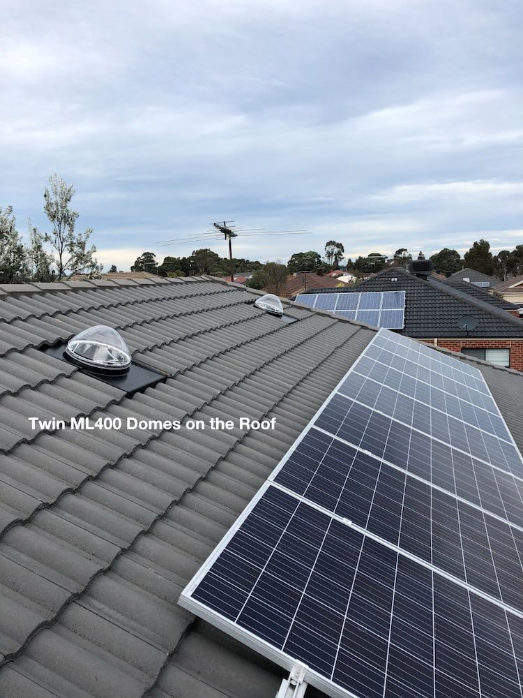 Dark Tiled Roof With Solar Panels and Two Dome-shaped Skylights — Gold Coast Skylights in Slacks Creek, QLD