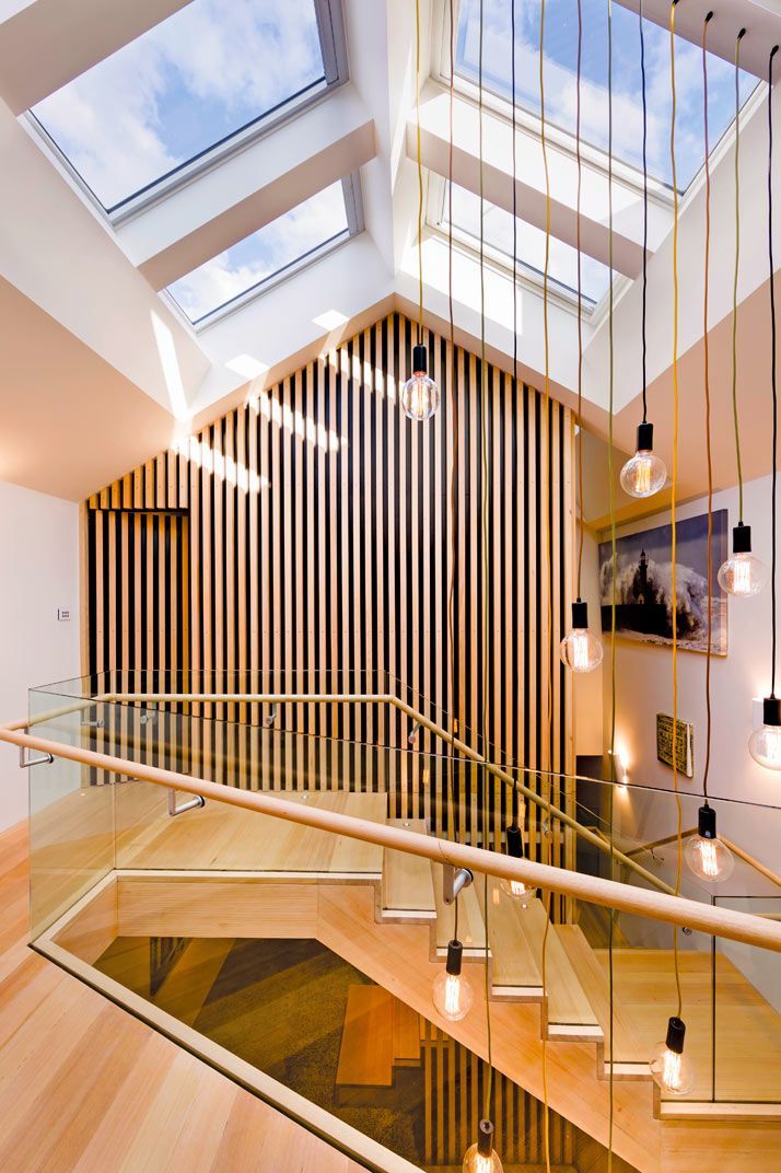 Interior View of a Bright Staircase With Wooden Steps, Glass Railings, and Skylights — Gold Coast Skylights in Slacks Creek, QLD