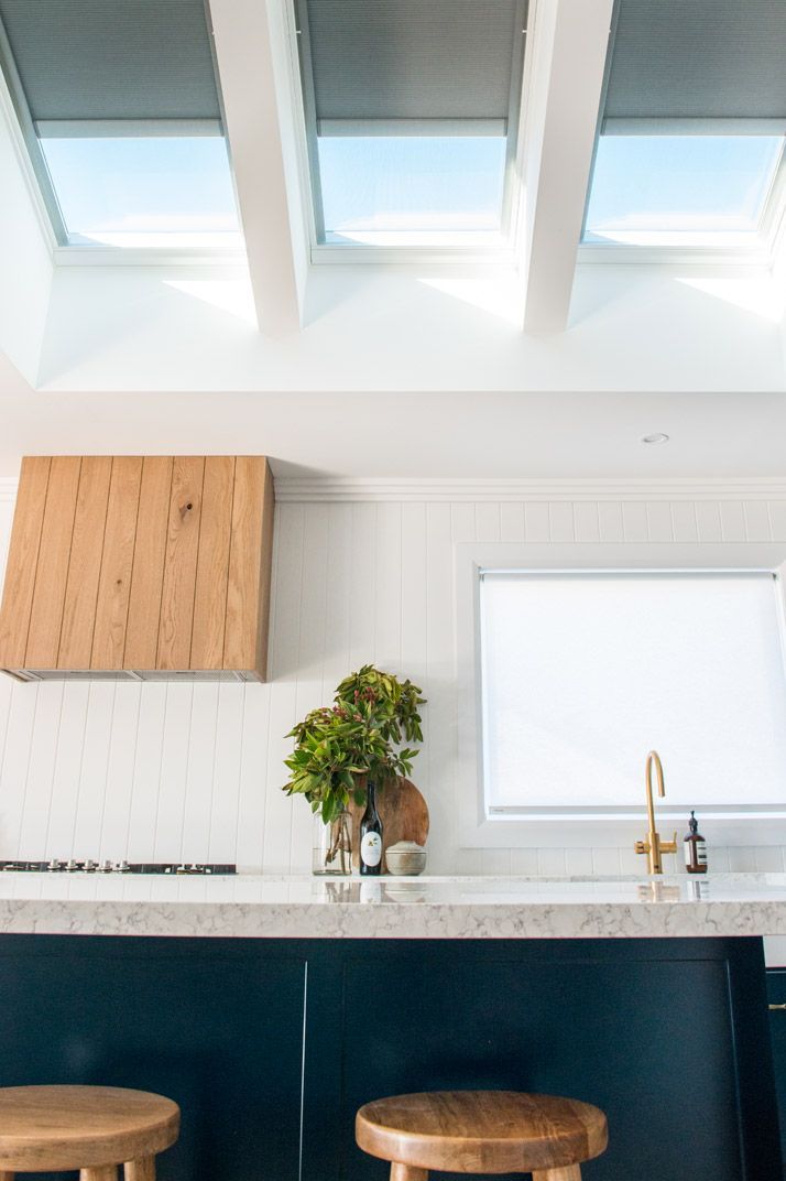 Kitchen With Blue Cabinets, White Countertop, Wood Stools, and Skylights — Gold Coast Skylights in Helensvale, QLD