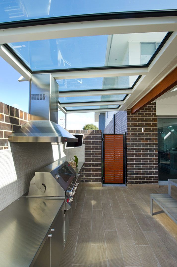 Outdoor Kitchen With a Stainless Steel Grill Under a Glass Roof — Gold Coast Skylights in Slacks Creek, QLD