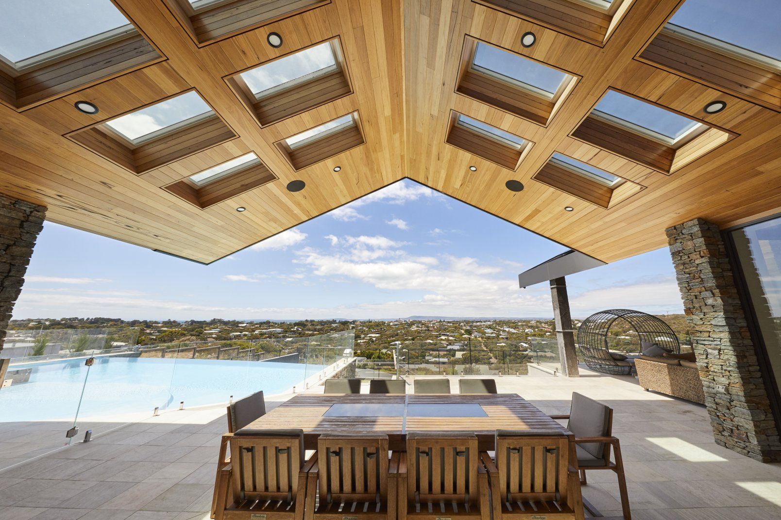 Patio With Wooden Table and Chairs Under a Wood Ceiling With Skylights — Gold Coast Skylights in Slacks Creek, QLD