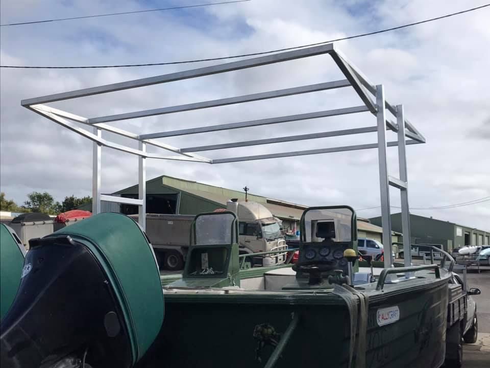 A Green Boat With a Canopy on Top of It — Jensen Welding & Fabrication in Chevallum, QLD