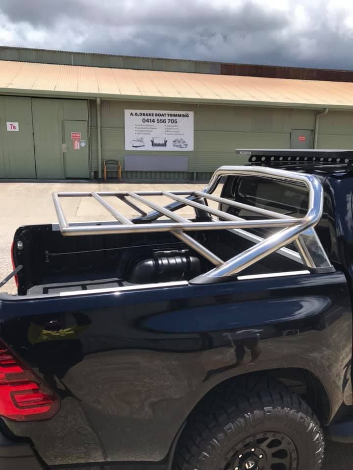 A Black Truck With a Roof Rack in the Bed is Parked in Front of a Building — Jensen Welding & Fabrication in Chevallum, QLD
