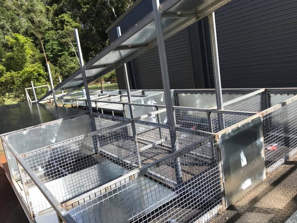 A Metal Structure With a Fence Around It is Sitting in Front of a Building — Jensen Welding & Fabrication in Chevallum, QLD