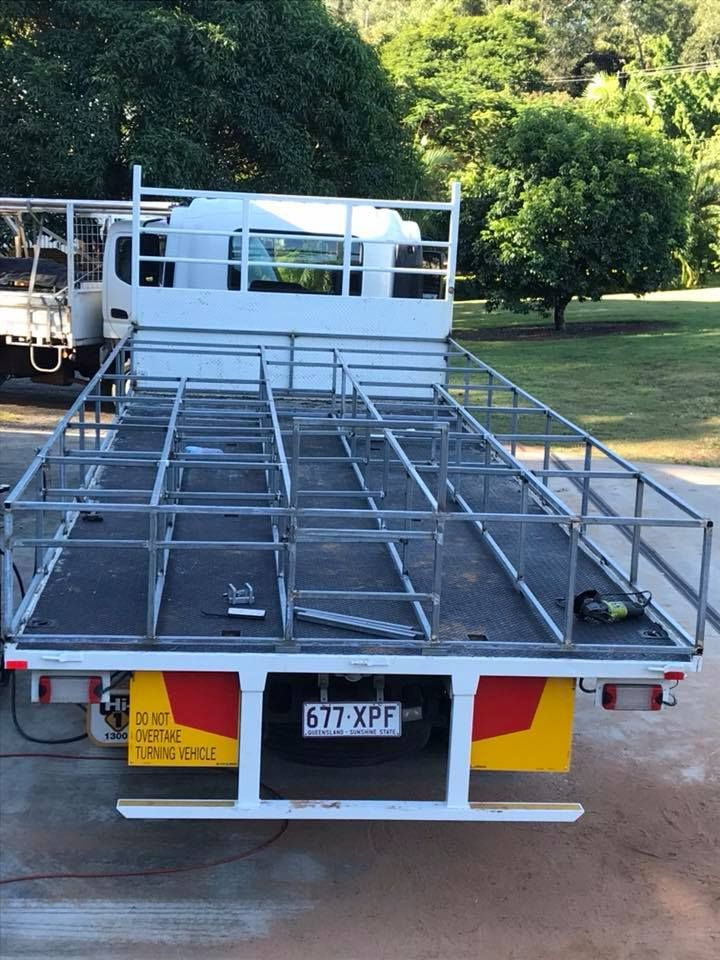 A White Truck With a Metal Frame on the Back is Parked in a Driveway — Jensen Welding & Fabrication in Chevallum, QLD