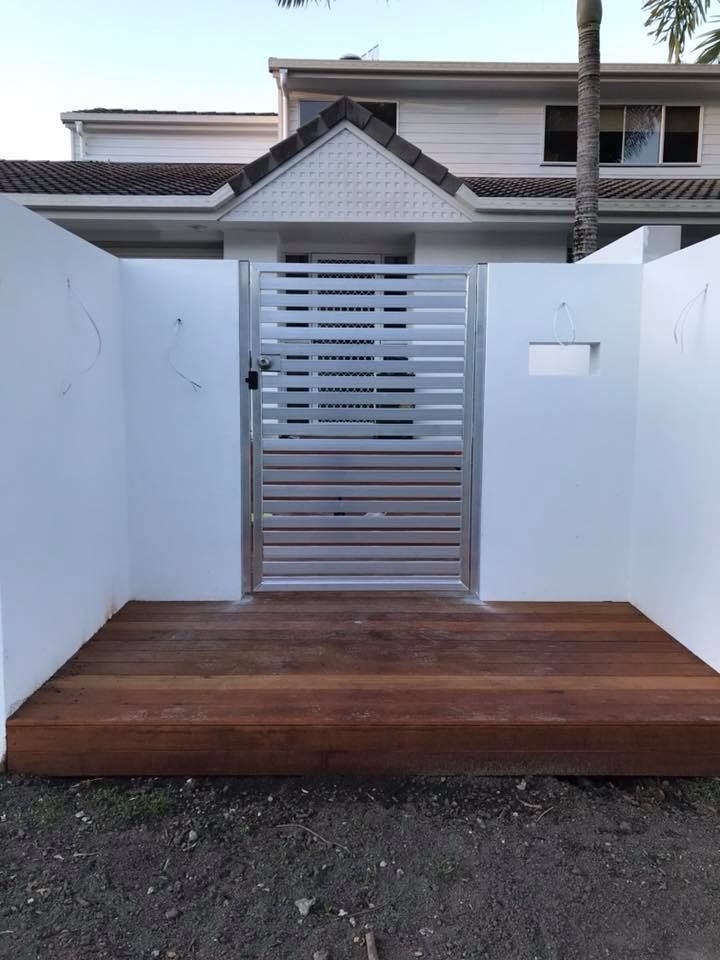 A White House With a Wooden Deck and a Metal Gate — Jensen Welding & Fabrication in Chevallum, QLD