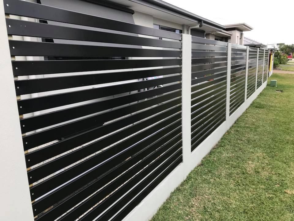 A Black Fence is Surrounding a House in a Residential Area — Jensen Welding & Fabrication in Maroochydore, QLD