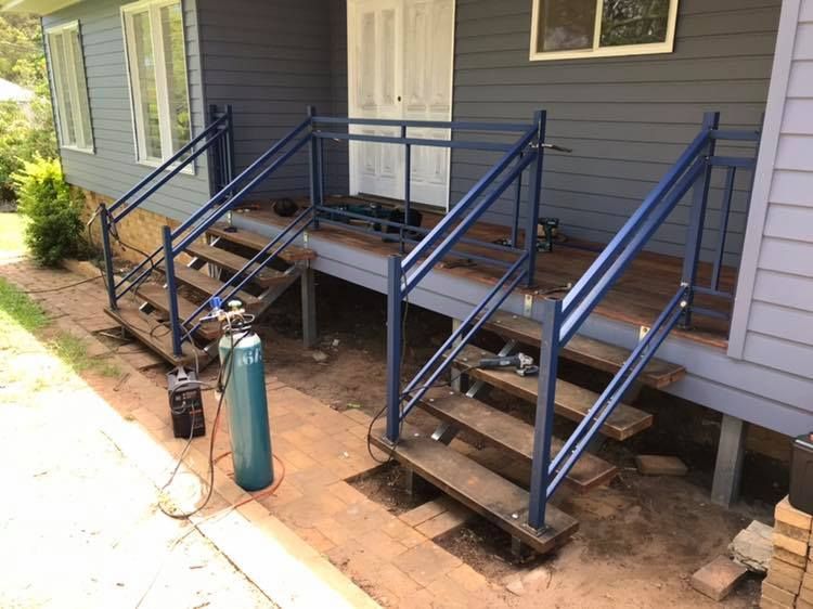 A Blue House With Stairs and a Fire Extinguisher in Front of It — Jensen Welding & Fabrication in Chevallum, QLD