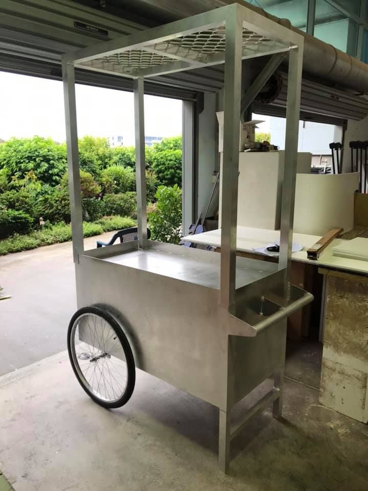 A Stainless Steel Cart With Wheels is Sitting in a Garage — Jensen Welding & Fabrication in Chevallum, QLD