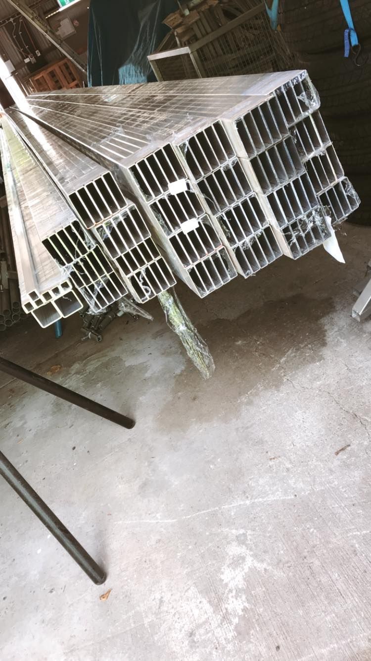 A Bunch of Aluminum Tubes Are Stacked on Top of Each Other on the Floor — Jensen Welding & Fabrication in Chevallum, QLD