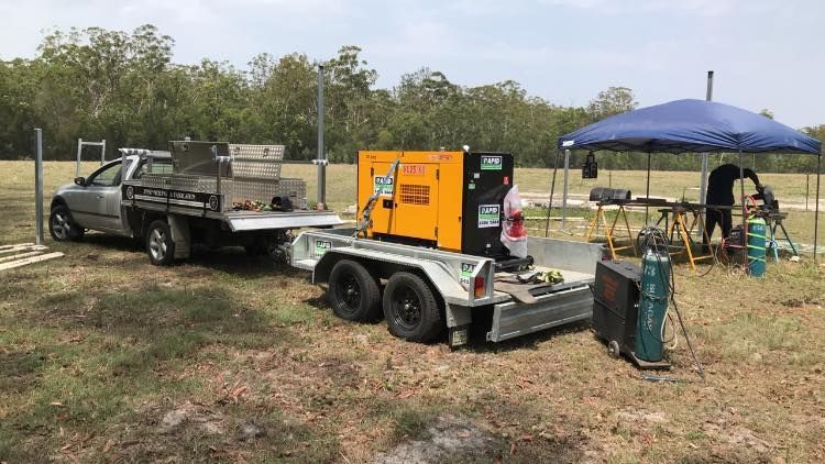 A Truck is Towing a Trailer With a Generator on It — Jensen Welding & Fabrication in Chevallum, QLD