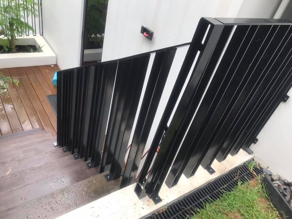 A Staircase With a Black Railing and a Wooden Floor — Jensen Welding & Fabrication in Chevallum, QLD