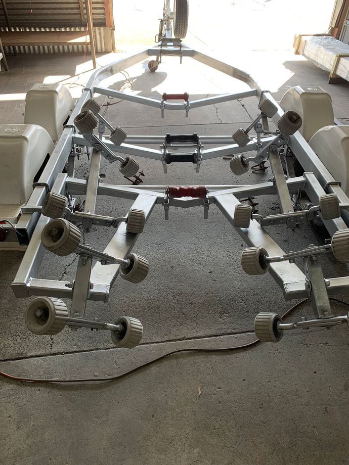 Metal framework with wheels in a workshop, viewed from the front on a concrete floor.  — Jensen Welding & Fabrication in Chevallum, QLD