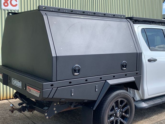 Black truck canopy with side panels mounted on a silver pickup, parked outdoors  — Jensen Welding & Fabrication in Chevallum, QLD