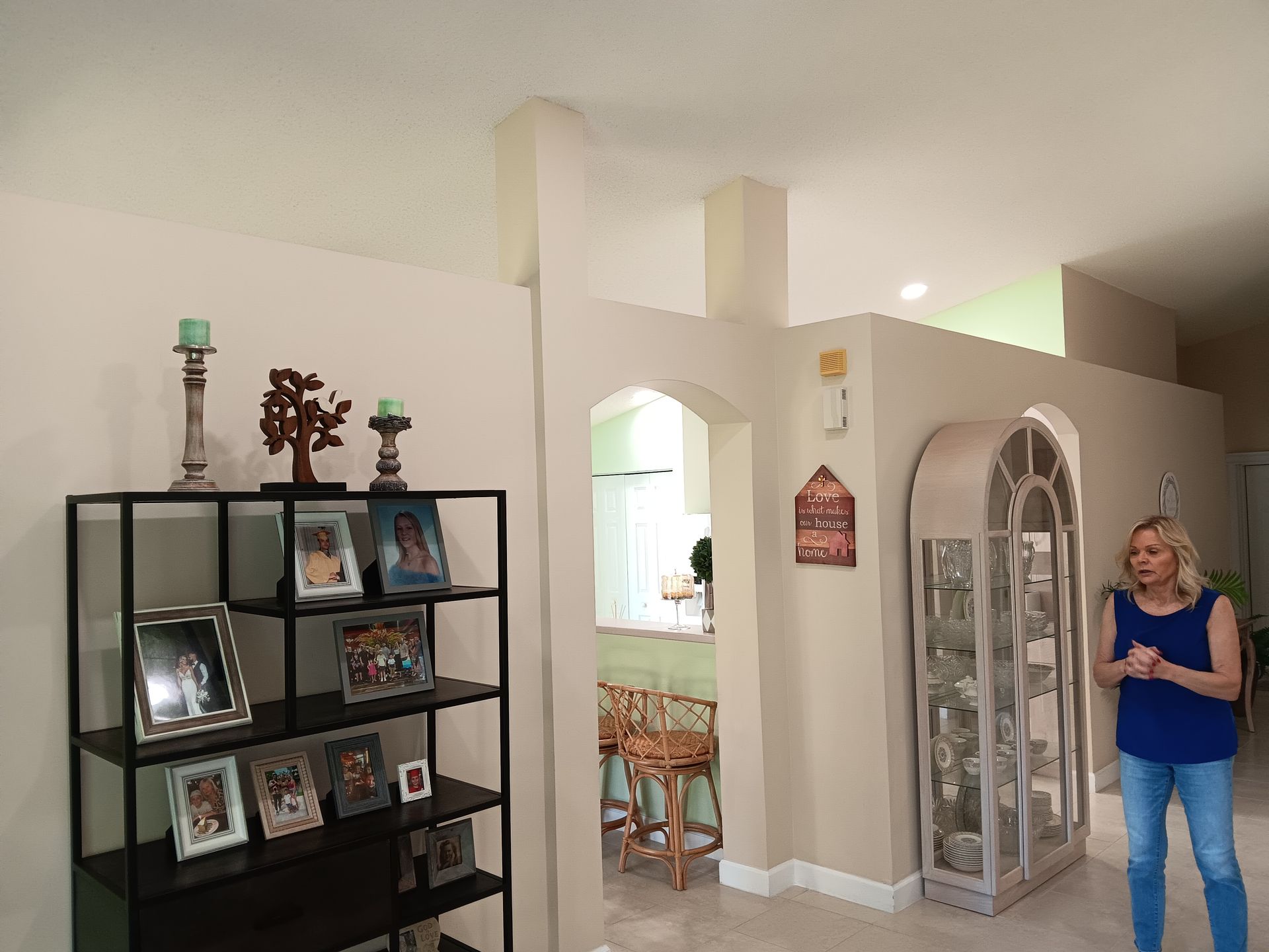Room being painted, with a ladder and paint swatches on the wall.
