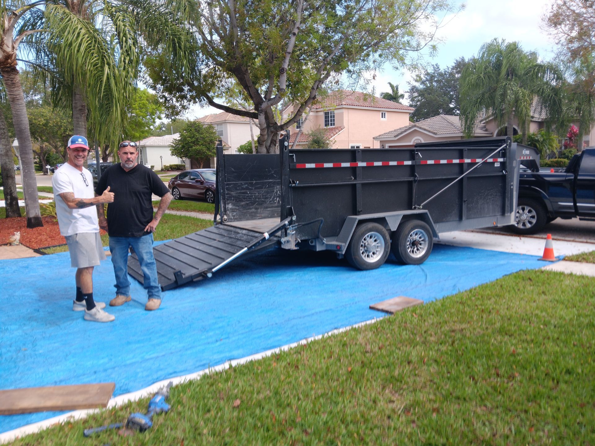 Couple carrying cardboard boxes while moving into a new home.
