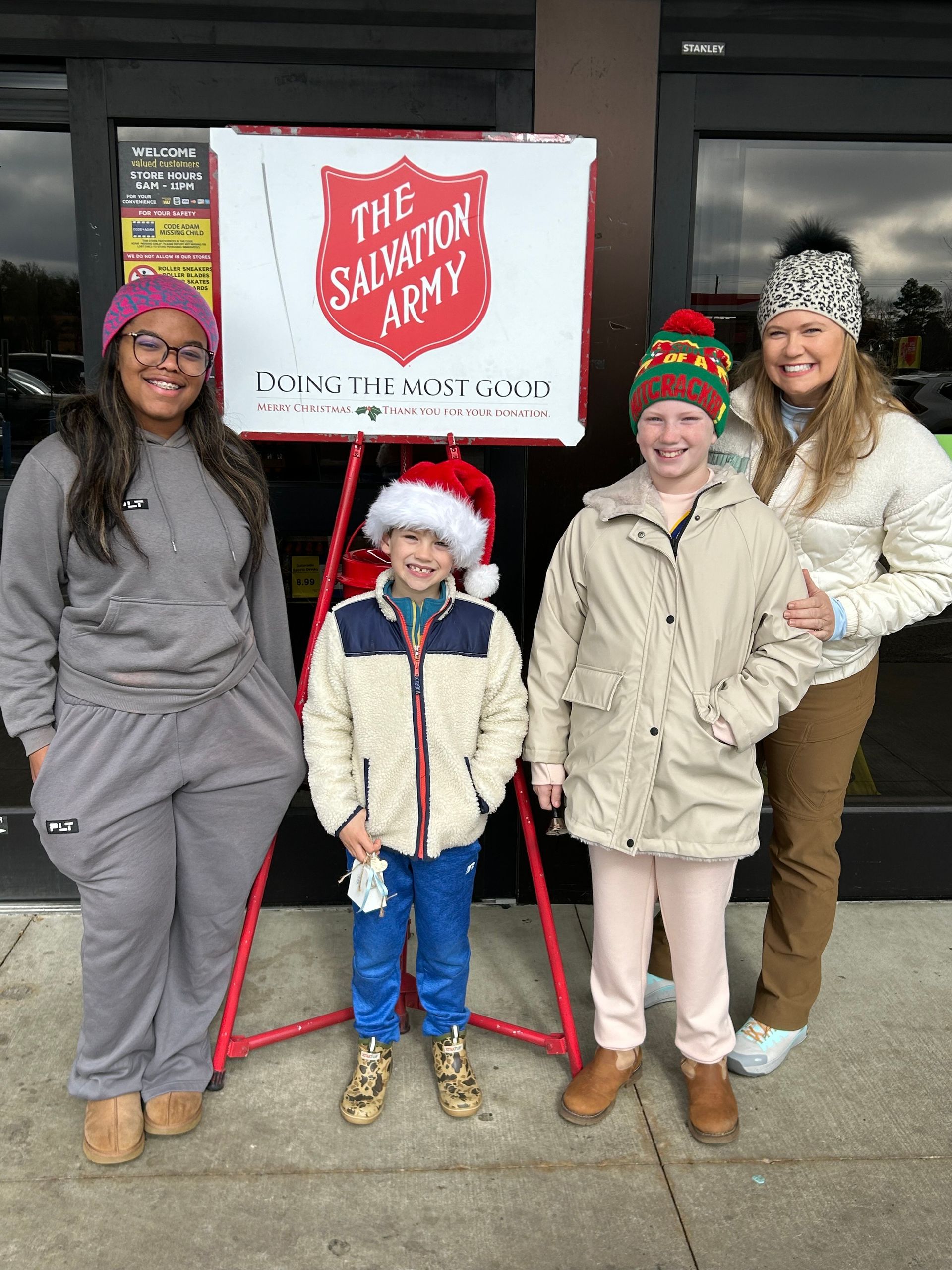 A woman is kneeling down in front of a pile of food.