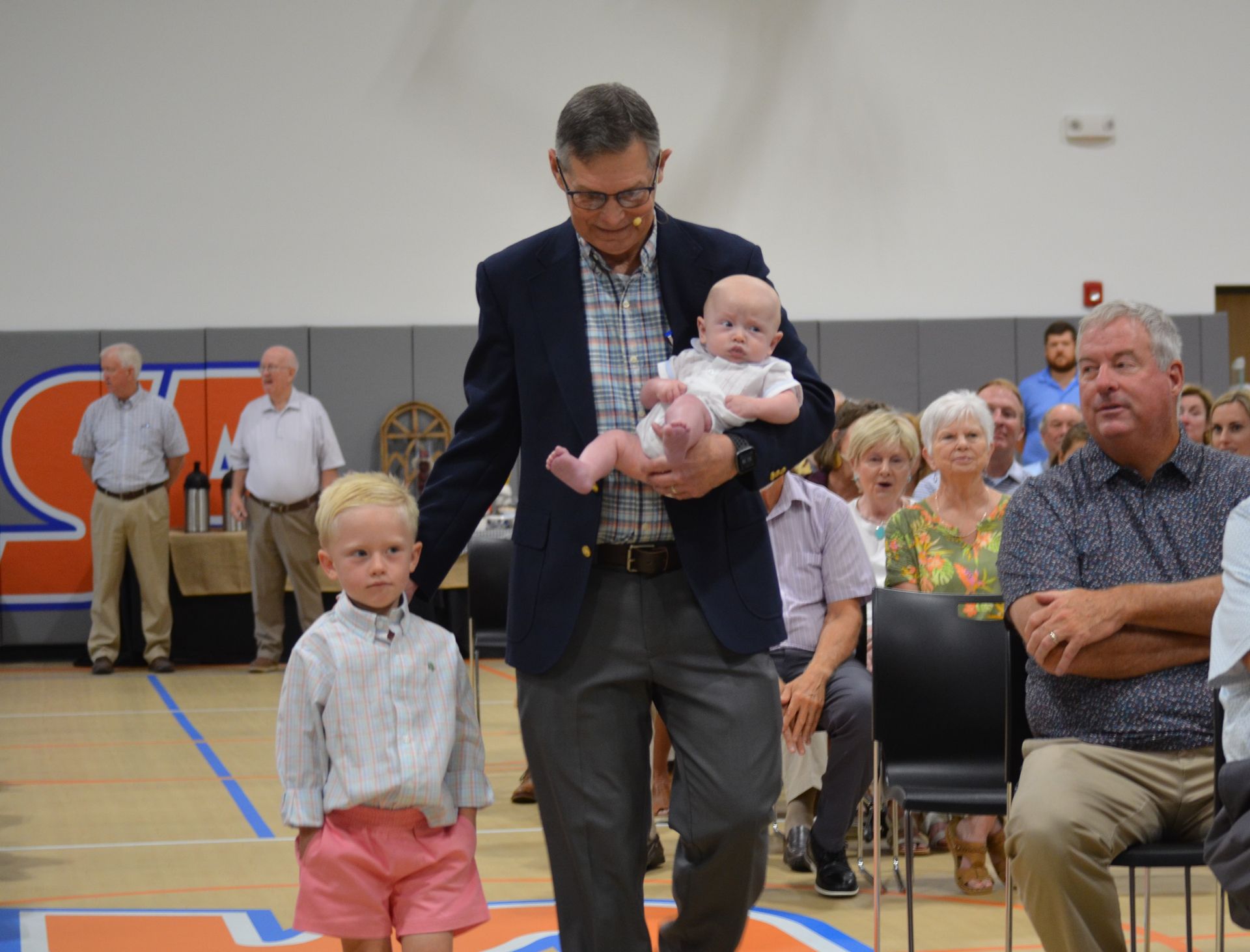 Welcome a newly baptized baby to our church fellowship with Pastor Bob Rambo.