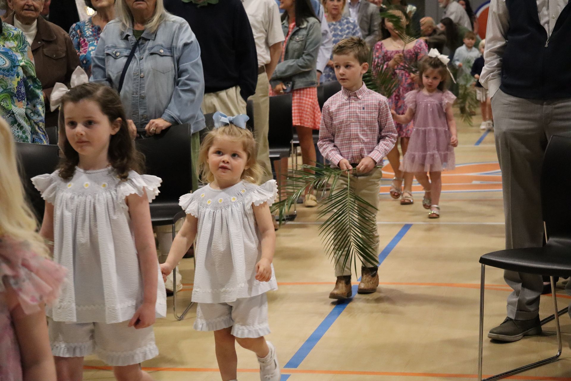 Children waving palms
