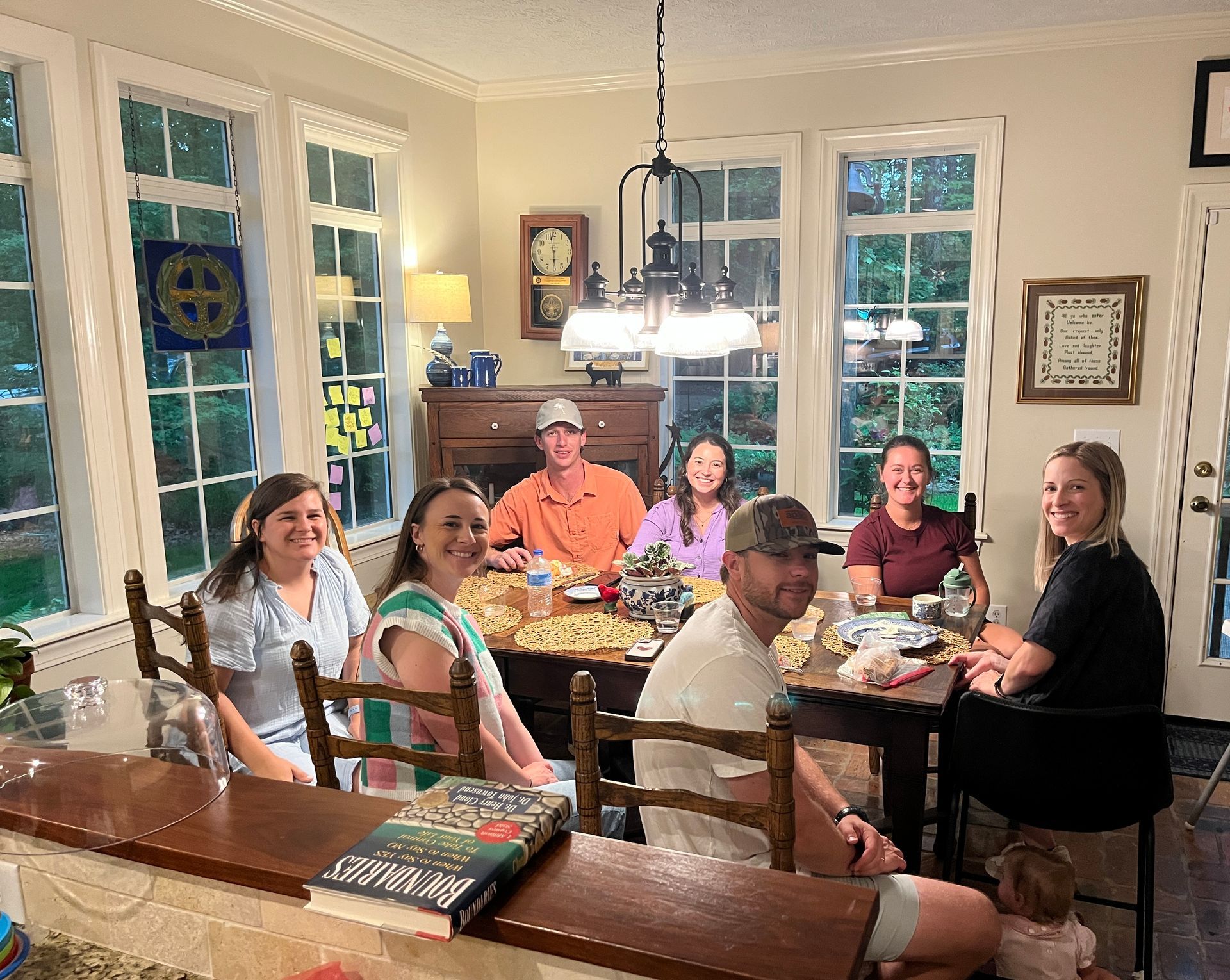 A group of people are sitting around a table in a room.
