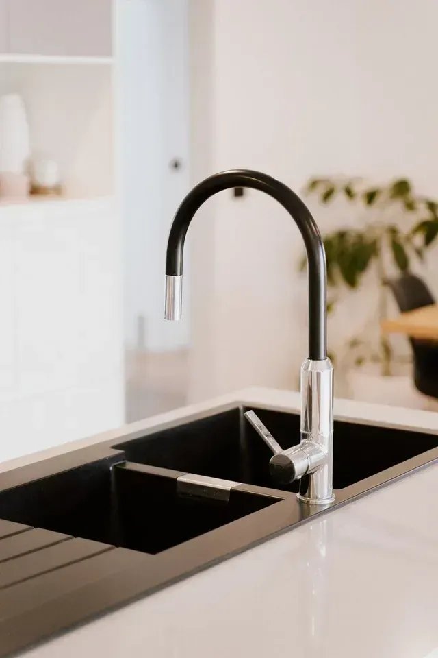 A kitchen sink with a black faucet in a kitchen in Vancouver, WA