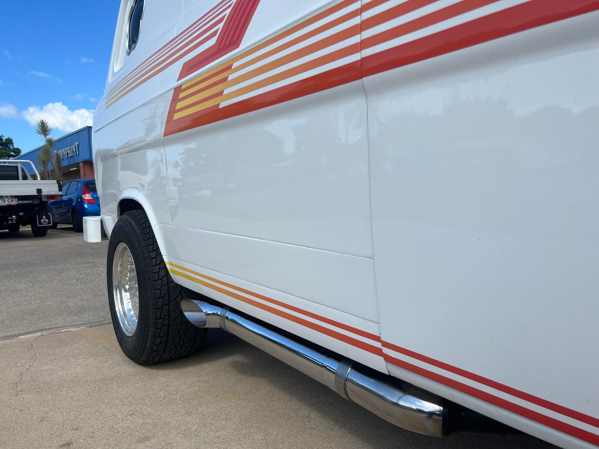 White Van With Red and Yellow Stripes — Aitkenvale Exhausts & Towbars Pty Ltd In Aitkenvale, QLD