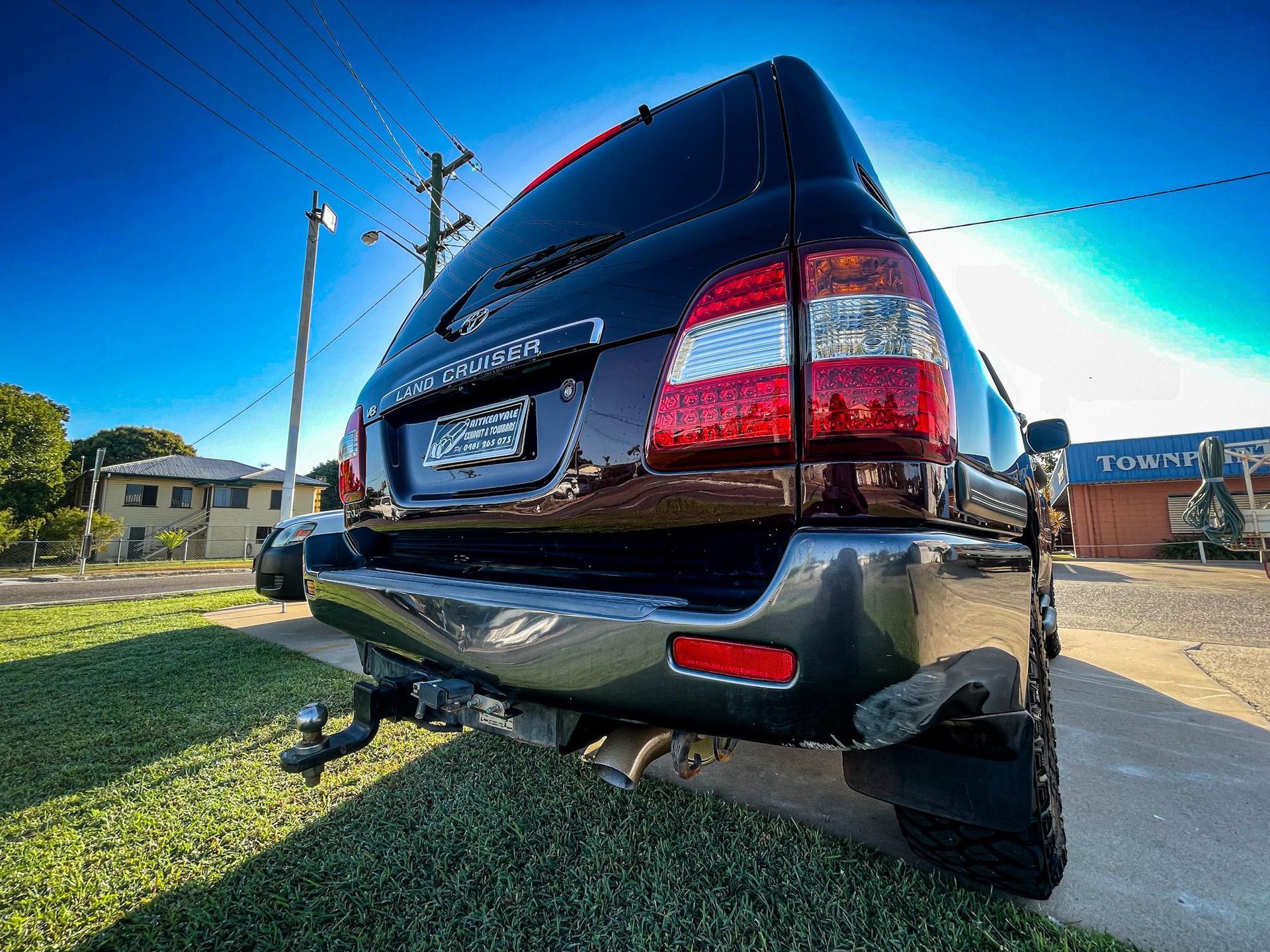 Black SUV From the Rear, Parked on Grass — Aitkenvale Exhausts & Towbars Pty Ltd In Aitkenvale, QLD