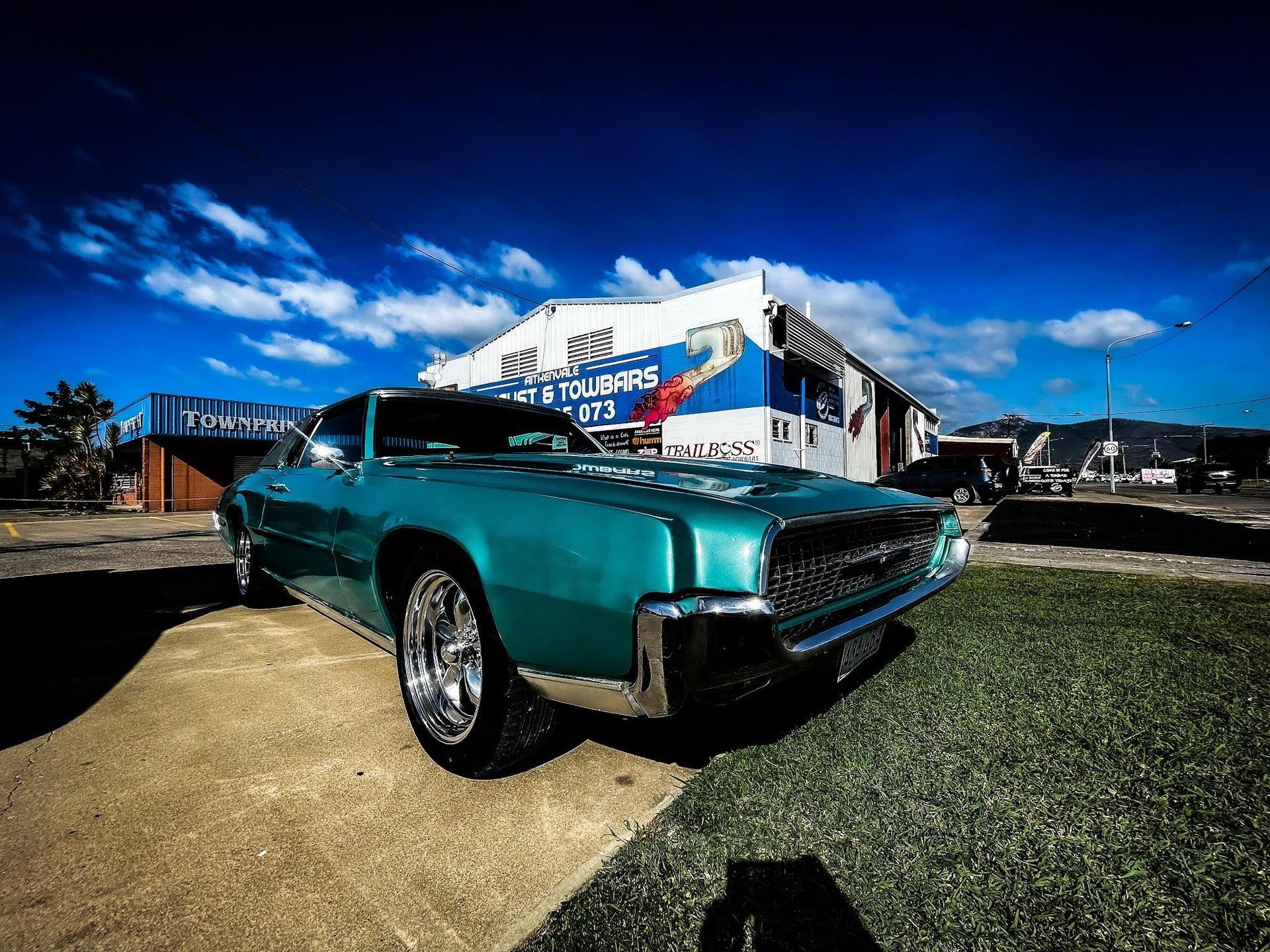 Teal Classic Car Parked in Front of a Blue and White Building — Aitkenvale Exhausts & Towbars Pty Ltd In Aitkenvale, QLD