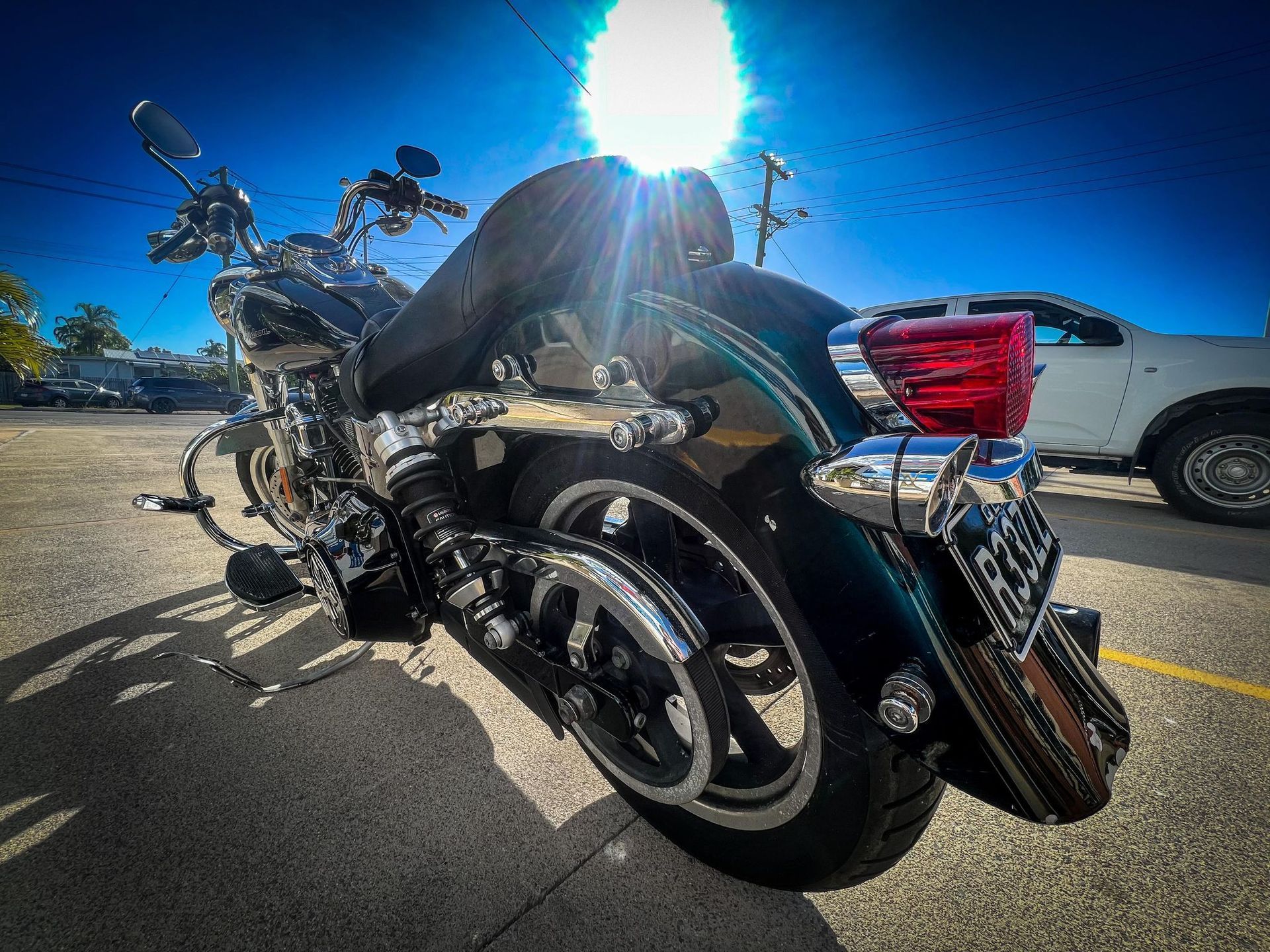 Dark Teal Motorcycle Parked on Pavement — Aitkenvale Exhausts & Towbars Pty Ltd In Aitkenvale, QLD