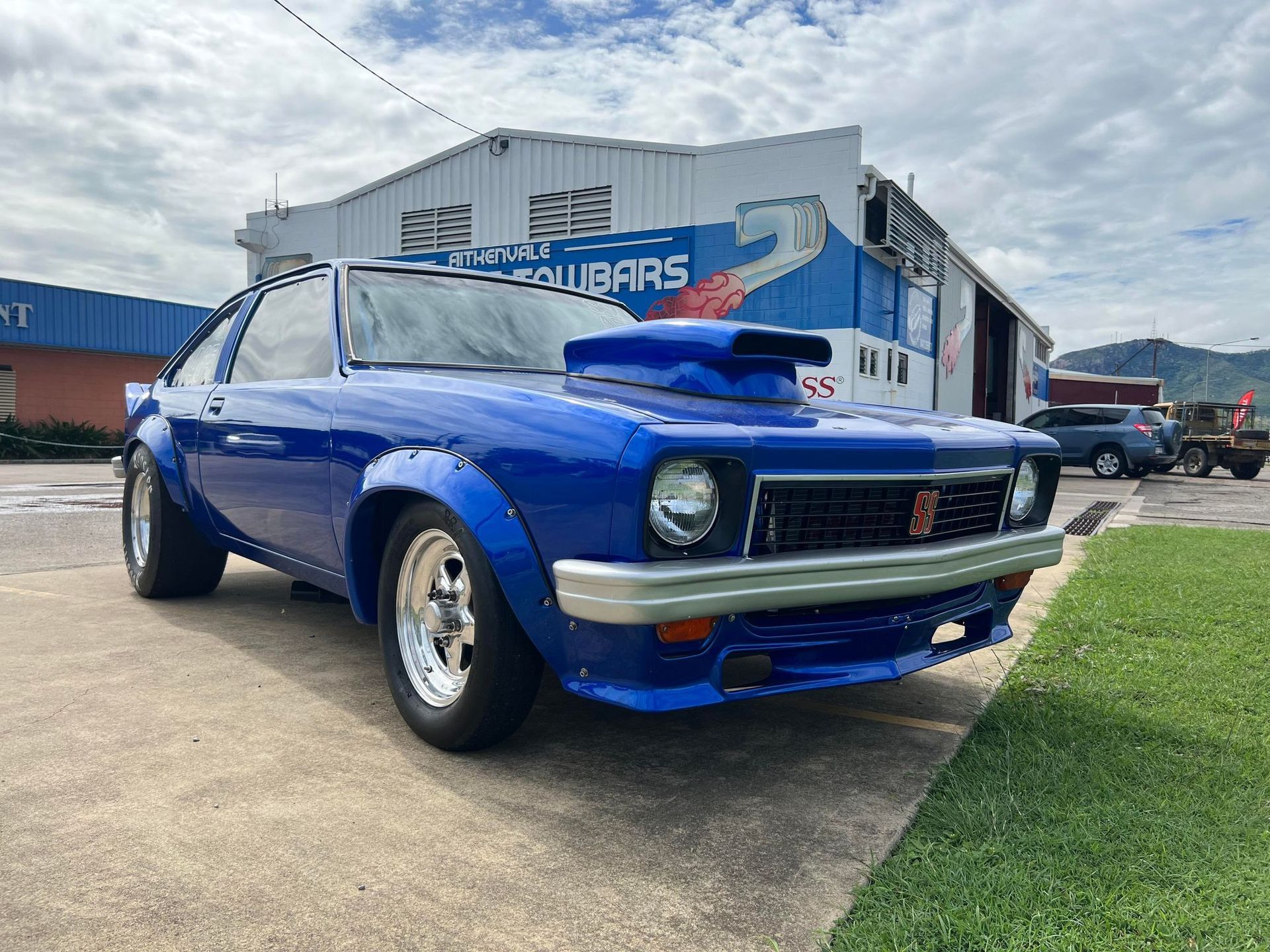 Blue Custom Car With Large Hood Scoop Parked Outside — Aitkenvale Exhausts & Towbars Pty Ltd In Aitkenvale, QLD