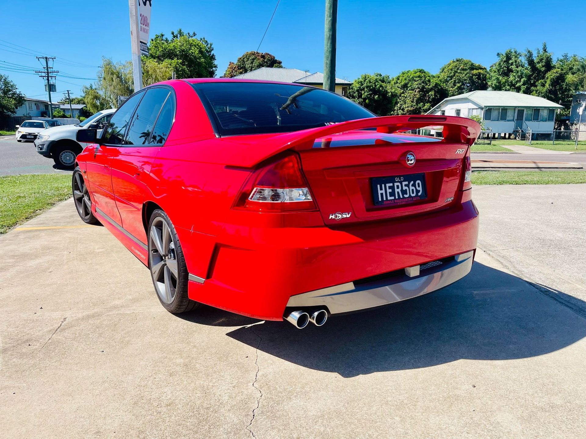 Red Holden Sedan Parked on a Driveway — Aitkenvale Exhausts & Towbars Pty Ltd In Aitkenvale, QLD