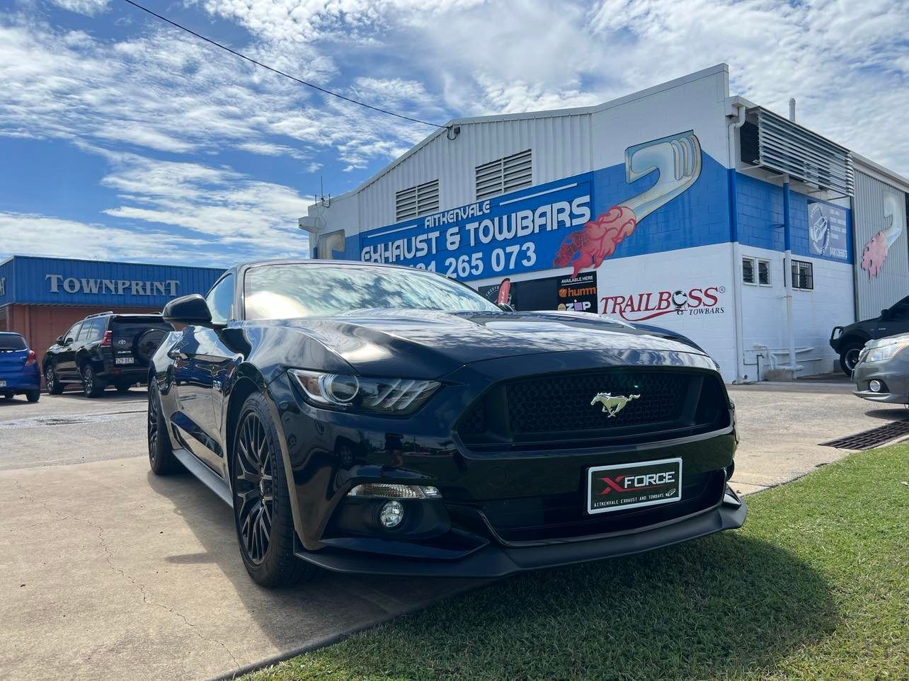 Black Ford Mustang Parked in Front of a Shop — Aitkenvale Exhausts & Towbars Pty Ltd In Aitkenvale, QLD
