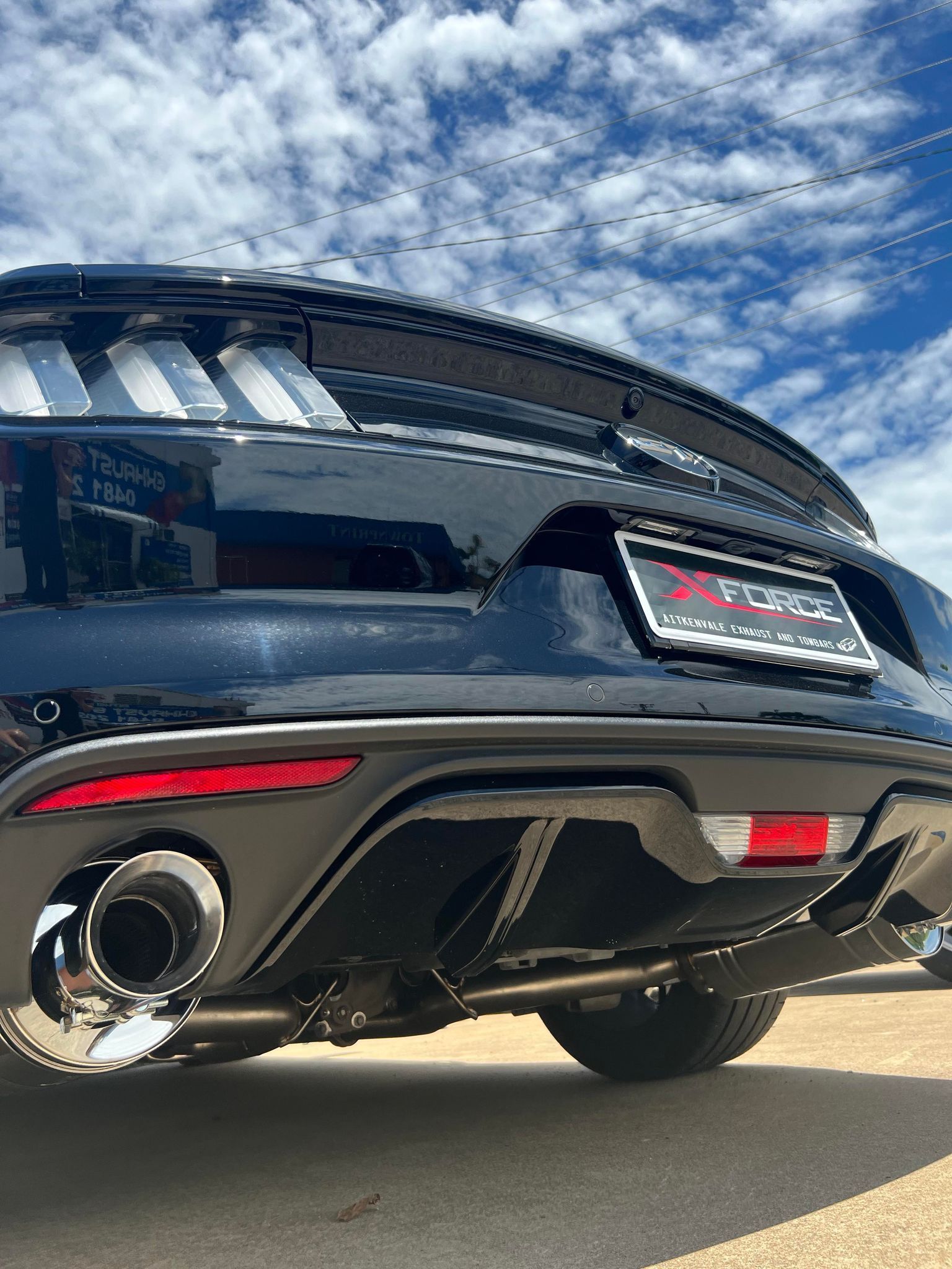 Rear View of a Black Ford Mustang With Chrome Exhaust Pipes — Aitkenvale Exhausts & Towbars Pty Ltd In Aitkenvale, QLD
