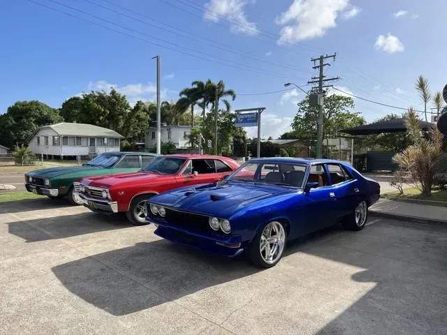 Three Classic Cars in Green, Red, and Blue Parked — Aitkenvale Exhausts & Towbars Pty Ltd In Aitkenvale, QLD