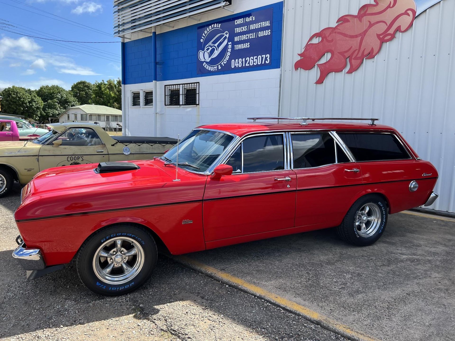 Red Vintage Station Wagon Parked Outside a Building — Aitkenvale Exhausts & Towbars Pty Ltd In Aitkenvale, QLD