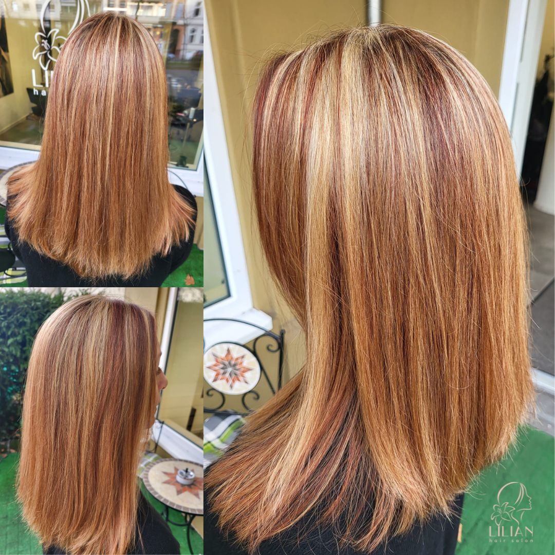 Eine Frau mit langen braunen Haaren steht vor einem Fenster.