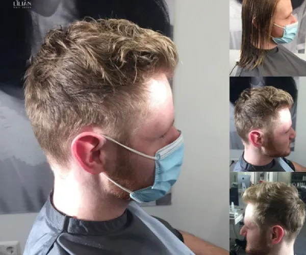 Ein Mann mit Gesichtsmaske lässt sich die Haare schneiden