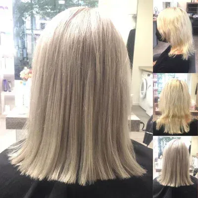 Eine Frau mit blonden Haaren sitzt in einem Stuhl in einem Salon.