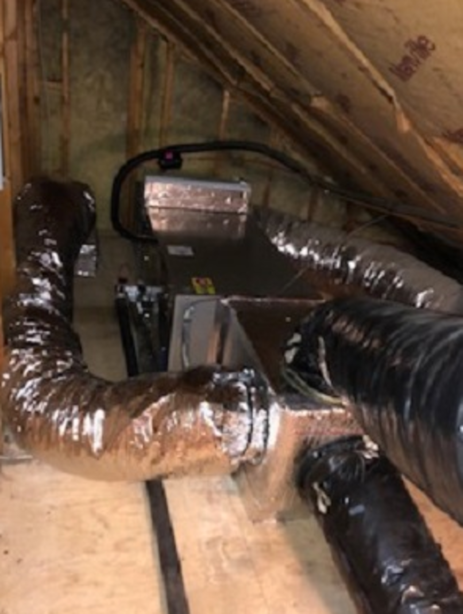 A bunch of pipes are connected to a machine in a room.